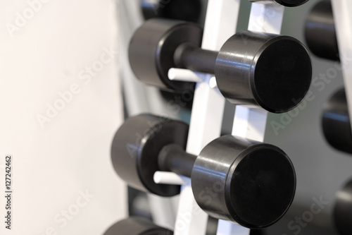 The image of dumbbells in a fitness hall
