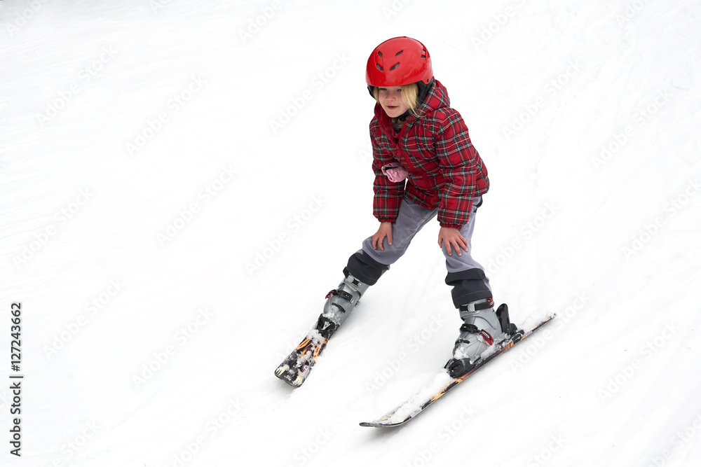 Happy child girl enjoying vacation in winter resort. Little girl skiing in mountains. Active sportive toddler wearing helmet learning to ski. Winter sport for family. Skier racing in snow. Happy child girl enjoying vacation in winter resort. Little girl skiing in mountains. Active sportive toddler wearing helmet learning to ski. Winter sport for family. Skier racing in snow.