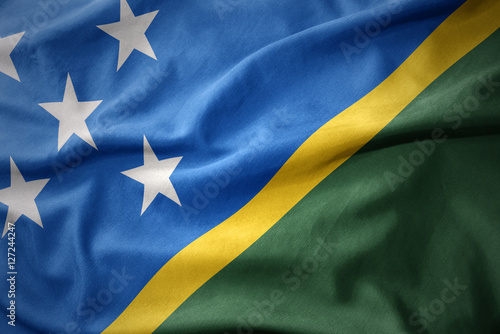 waving colorful flag of Solomon Islands.