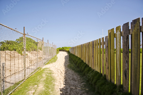 Sandy Path Between Two Fences