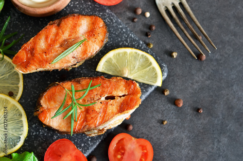 Salmon steak grilled with peppers and lemon