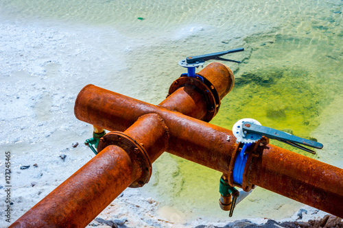 Rusted metal pipes at Chaqia Salt lakes, China photo