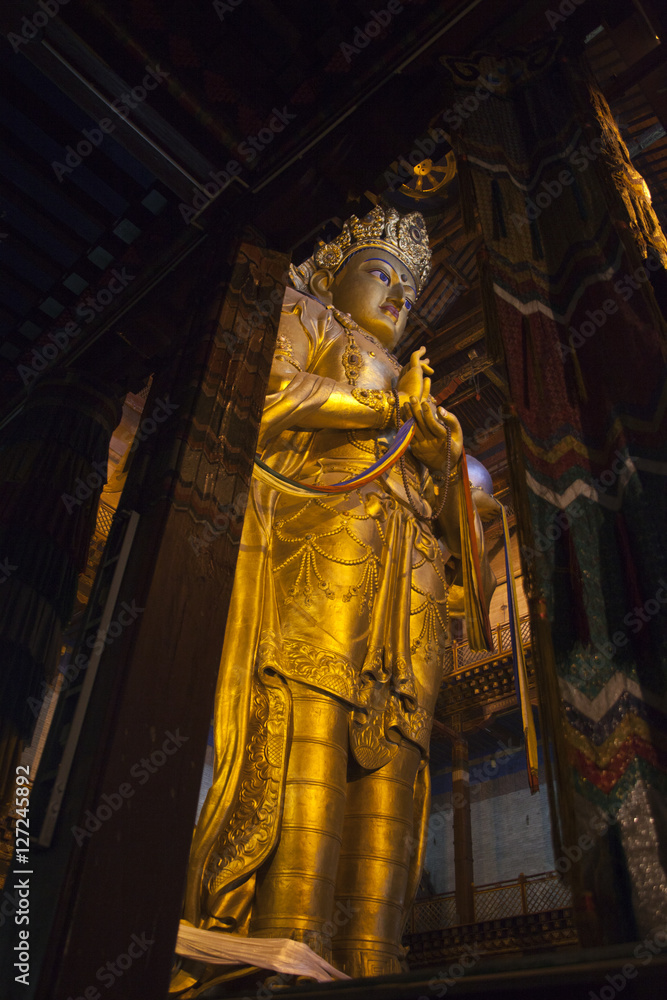 Giant golden Buddhist statue in a Mongolian temple