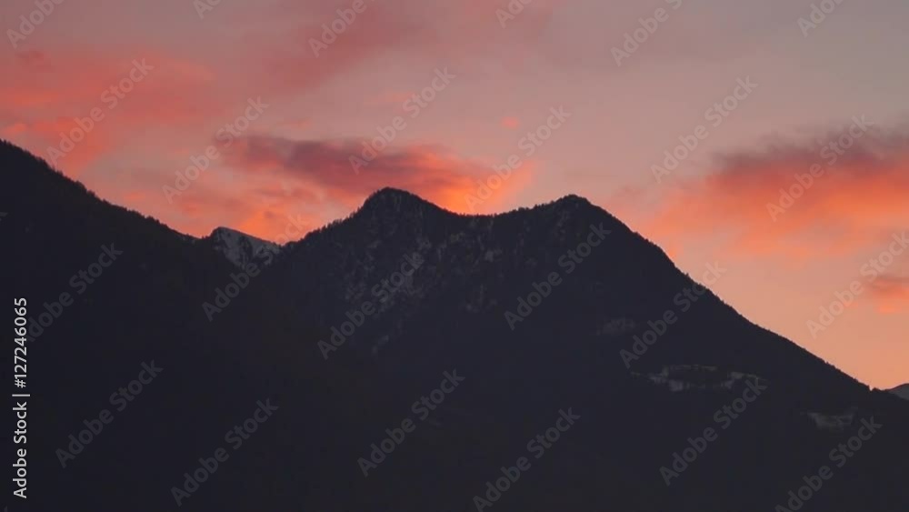 Video of cloudy sunset, colorful red sky, sky adn mountains on background. Video al tramonto con nuvole e cielo rosso, sfondo montagne Video of cloudy sunset, colorful red sky, sky adn mountains on background. Video al tramonto con nuvole e cielo rosso, sfondo montagne