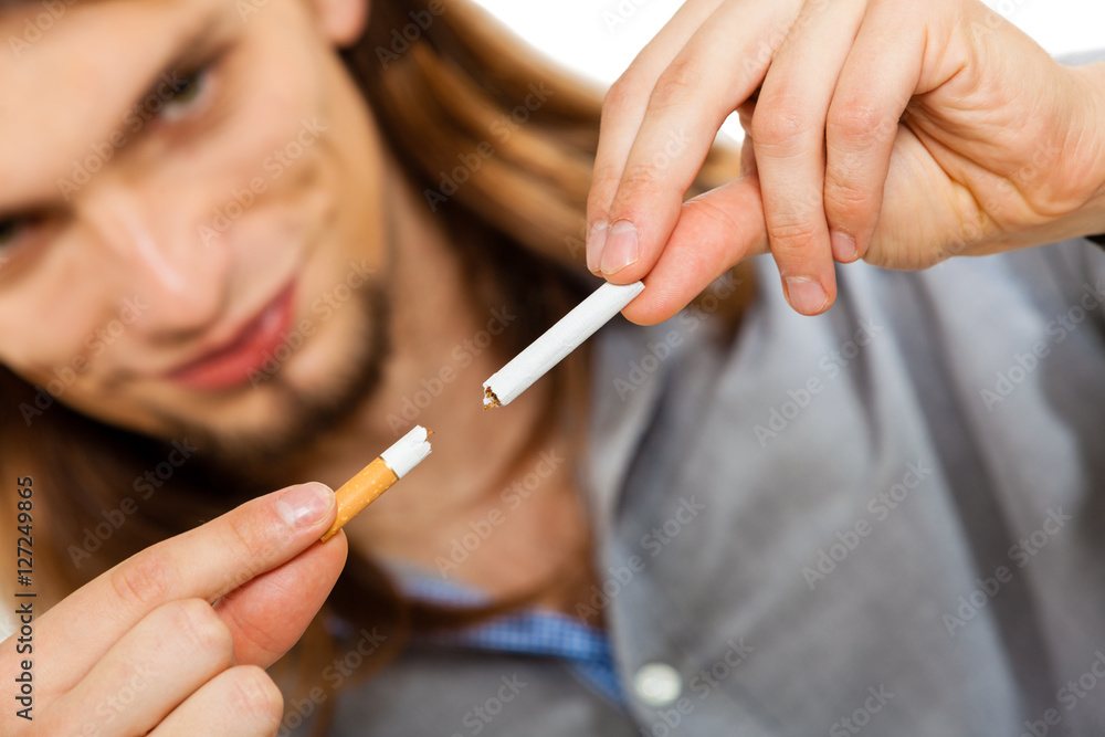 Young man is breaking a cigarette Young man is breaking a cigarette