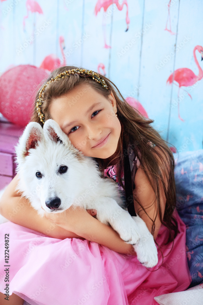girl holds a dog in the room. The concept of friendship girl holds a dog in the room. The concept of friendship
