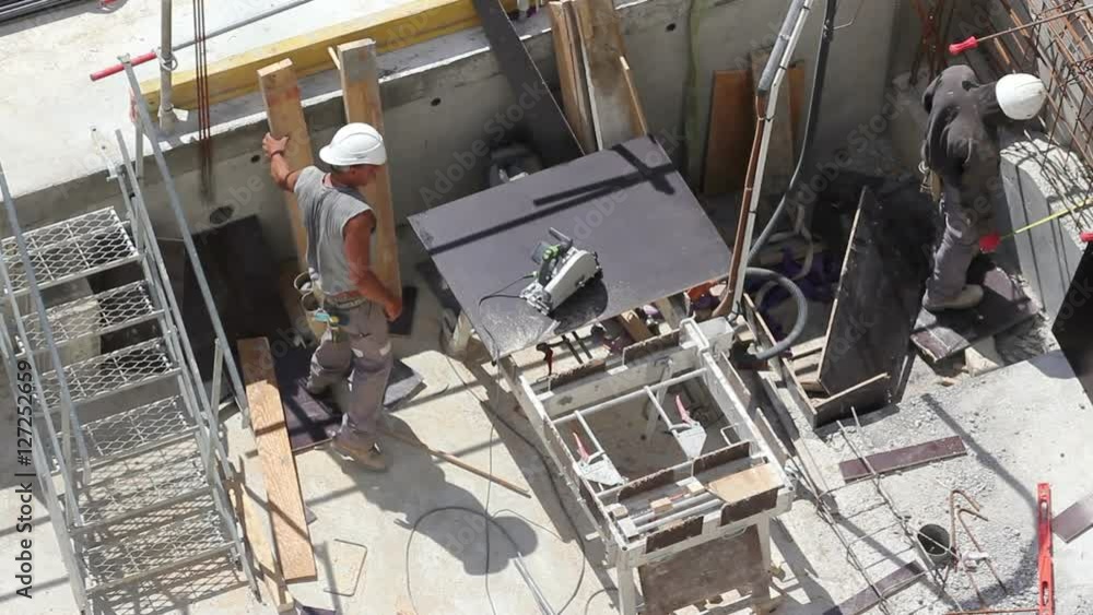 Male worker son a construction site with power tools