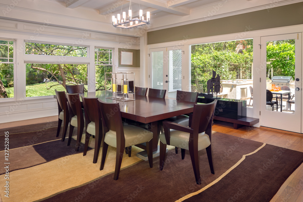 Large dining room with wood floors and area rug and outdoor dini Large dining room with wood floors and area rug and outdoor dini