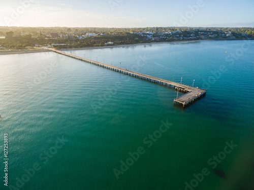 Aerial view of Frankston Pier in turquoise bay waters of Mornington Peninsula at sunrise. Melbourne, Victoria, Australia