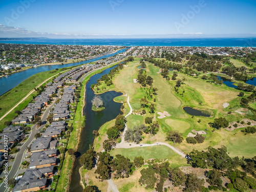 Aerial view of Bonbeach suburb, Patterson river and golf club on bright sunny day. Melbourne, Australia photo