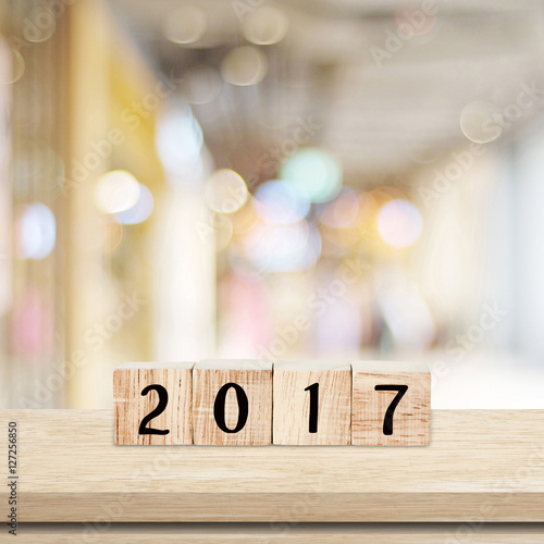 Wooden cubes with 2017 on table over blur bokeh background