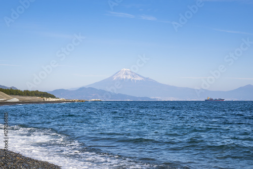 Stunning view of Fuji mountain from Miho no Matsubara Beach,Shizuoka,Japan, in soft blue sky with Haze and smoke effect at the mountain.