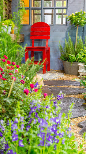 Relaxing area in cozy garden./ Relaxing area with red chair in cozy garden. 
