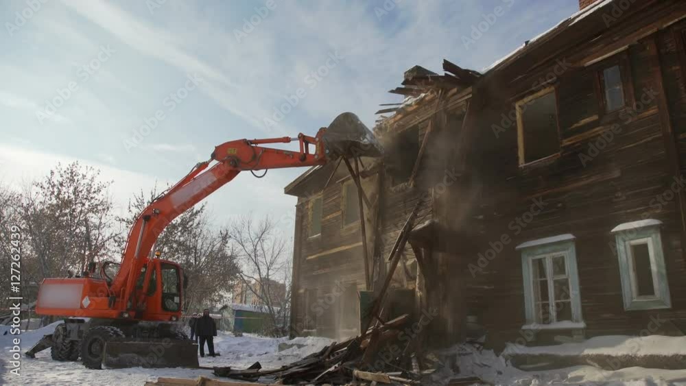 Rundown building. Special equipment for the demolition of dilapidated buildings. Bucket destroys the second floor two-storey building. Old and dilapidated housing demolished to build a new home. Rundown building. Special equipment for the demolition of dilapidated buildings. Bucket destroys the second floor two-storey building. Old and dilapidated housing demolished to build a new home.