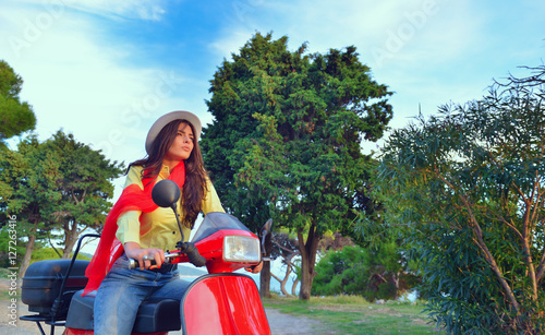 Attractive happy woman on a scooter