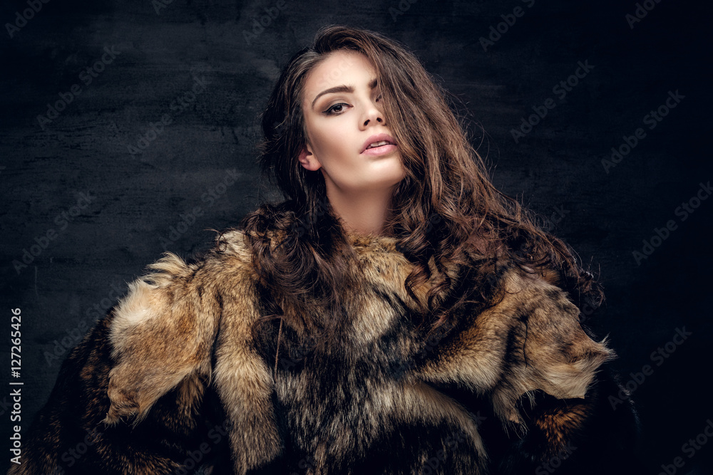 Sensual brunette female dressed in a fur coat. Sensual brunette female dressed in a fur coat.