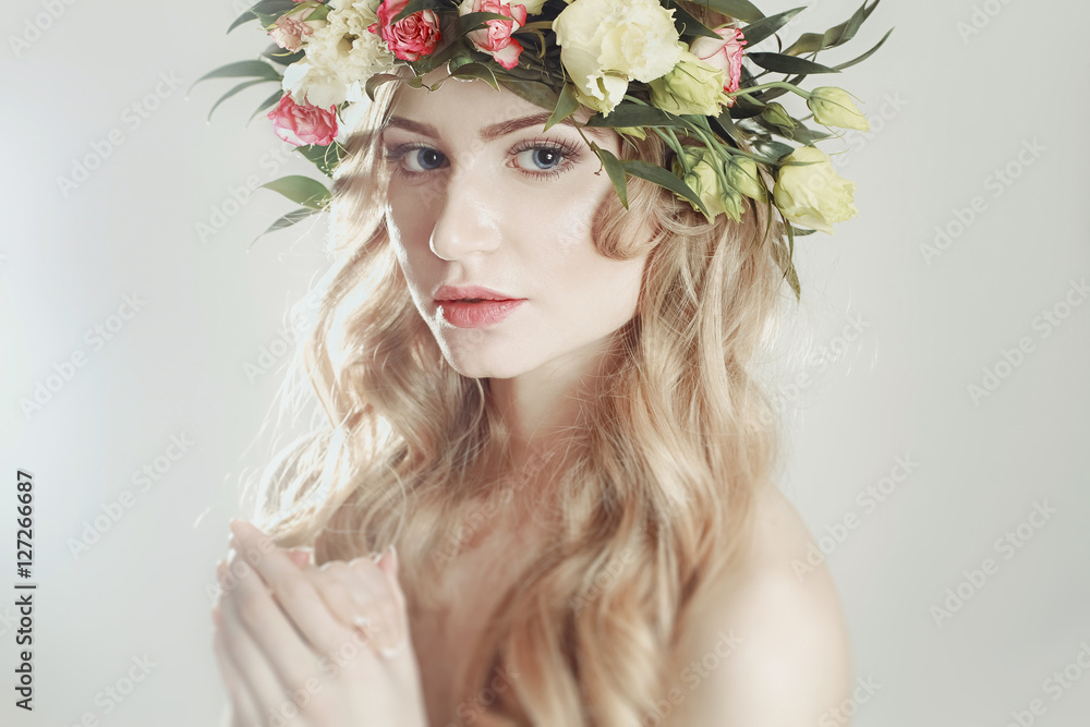 girl with a wreath of flowers on her head on white background