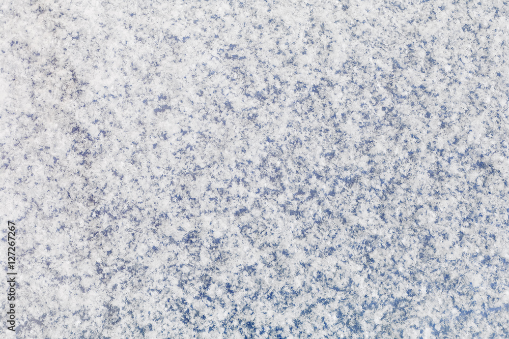 Background of a blue surface covered with fluffy snow
