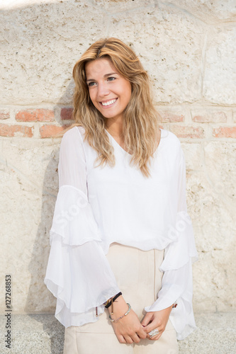 Portrait of a smiling young woman in the city