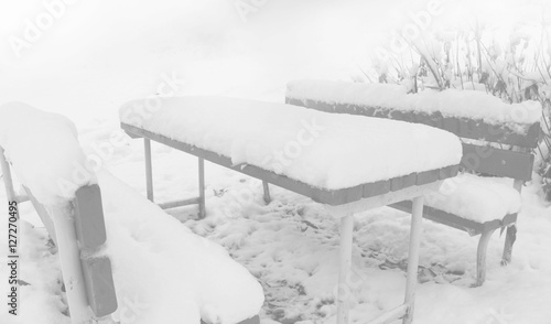 the bench and table in the snow