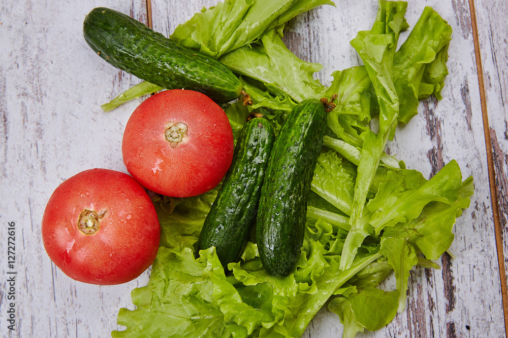 Salad, tomato and cucumber on rustic table Salad, tomato and cucumber on rustic table
