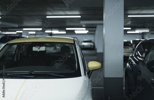 Yellow side mirror of car parked in garage. © ysbrandcosijn