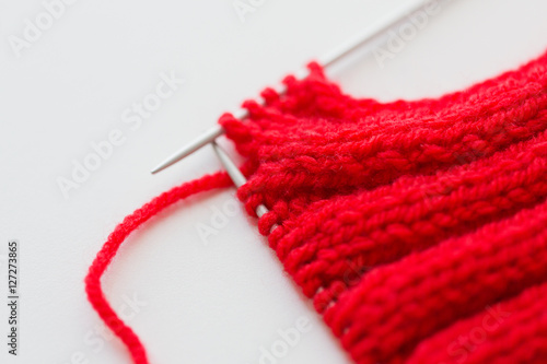 hand-knitted item with knitting needles