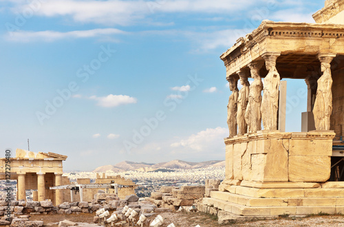 Ancient Greek Acropolis. The famous Porch of the Caryatids with six statues supporting the architrave, the southern part of the temple of the Erechtheion and fragment of the Propylaea photo