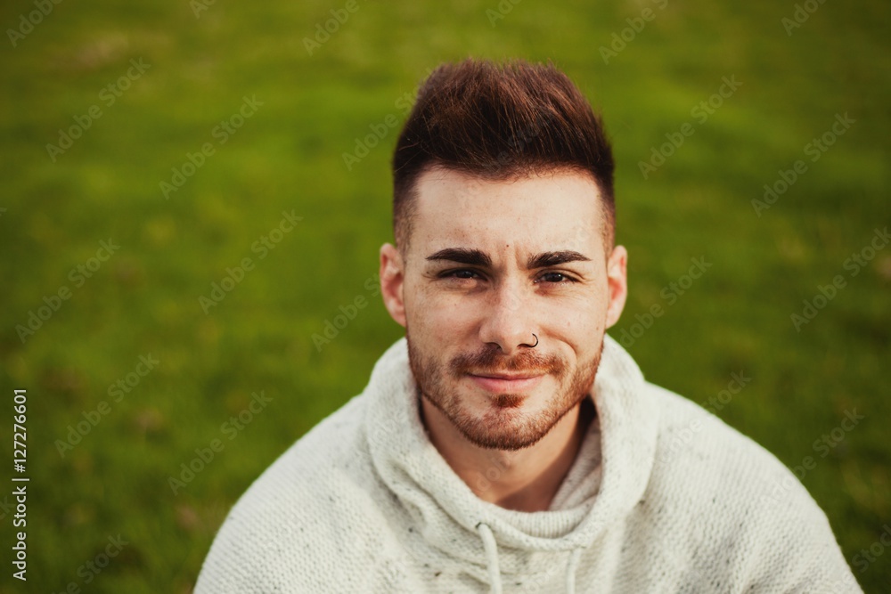 Fototapeta premium Attractive guy with beard in the meadow
