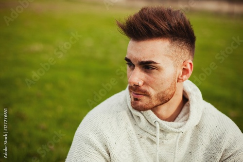 Attractive guy with beard in the meadow