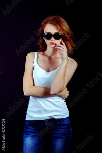 Portrait of beautiful girl. Freckled woman with wavy red hair an