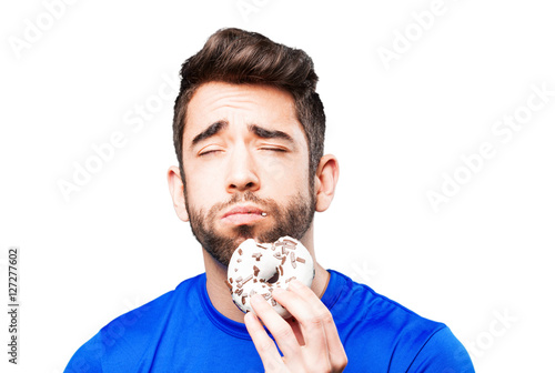 young man holding doughnut