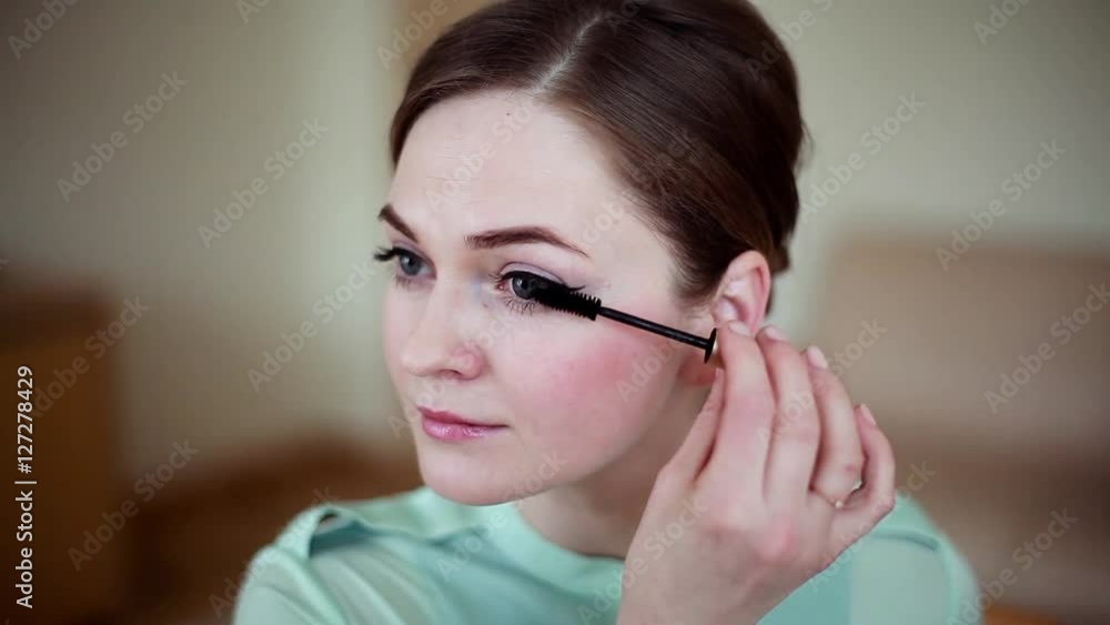 beautiful young woman doing eye make-up beautiful young woman doing eye make-up