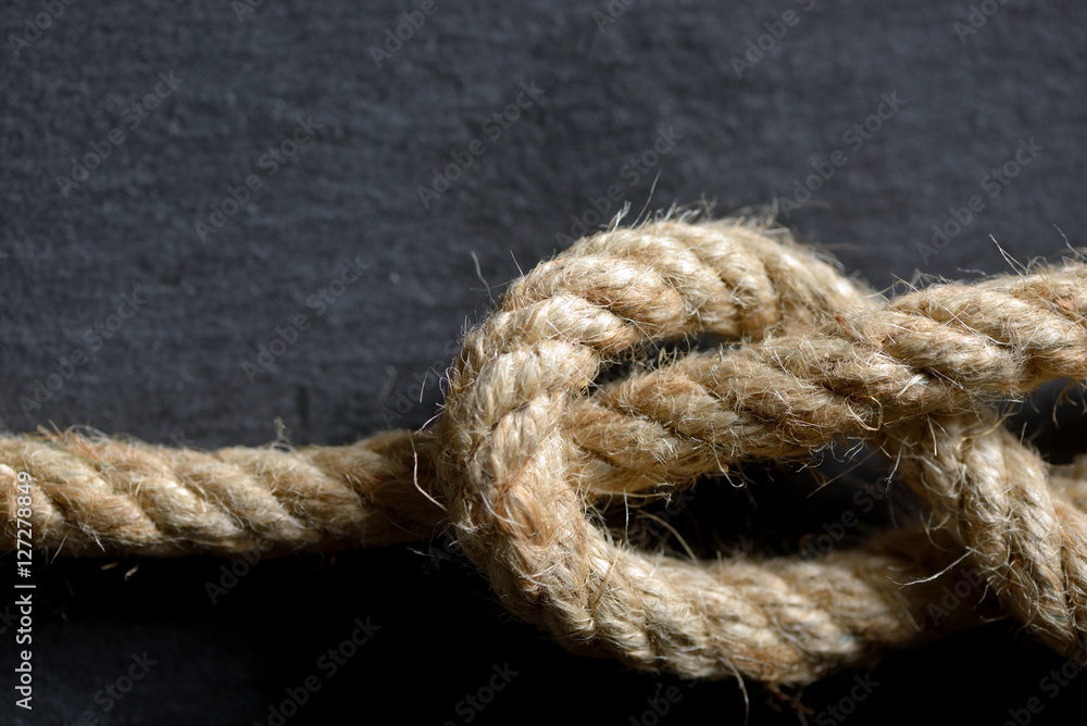 Fototapeta premium Rope knot isolated on black