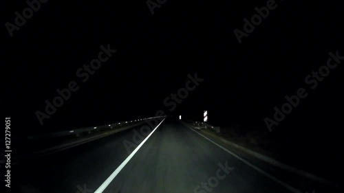 Night trip. Car moves mountainous road with many sharp turns.