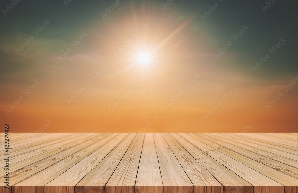 Wood planks floor with sunshine on sky near sunset time in summer background