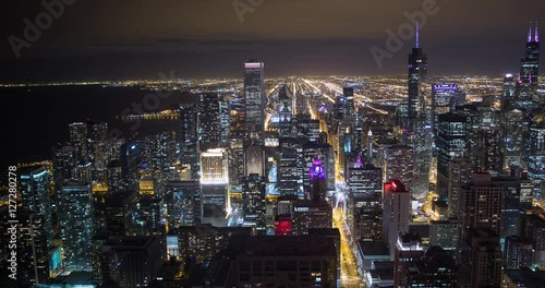 Chicago, Illinois, USA - view from John Hancock Center of City with Willis Tower (Sears Tower), Tribune Tower and NBC Tower facing south at night - Timelapse with pan left to right photo
