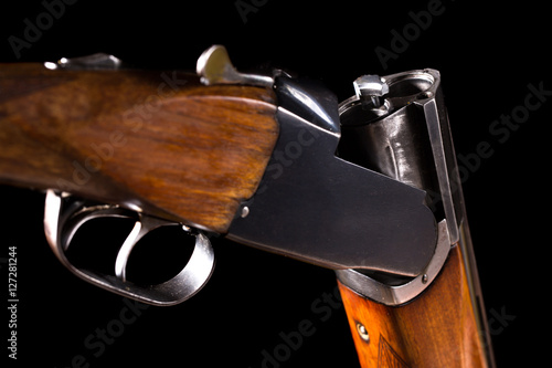 Double-barreled shotgun on a black background