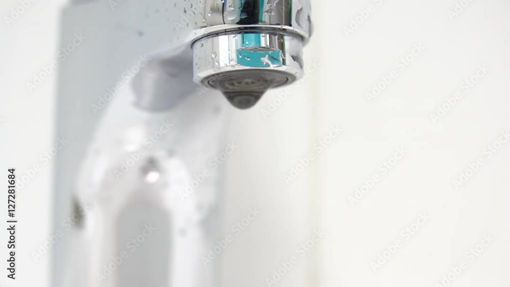 Bathroom sink and faucet with water dripping in close up. Bathroom sink and faucet with water dripping in close up.