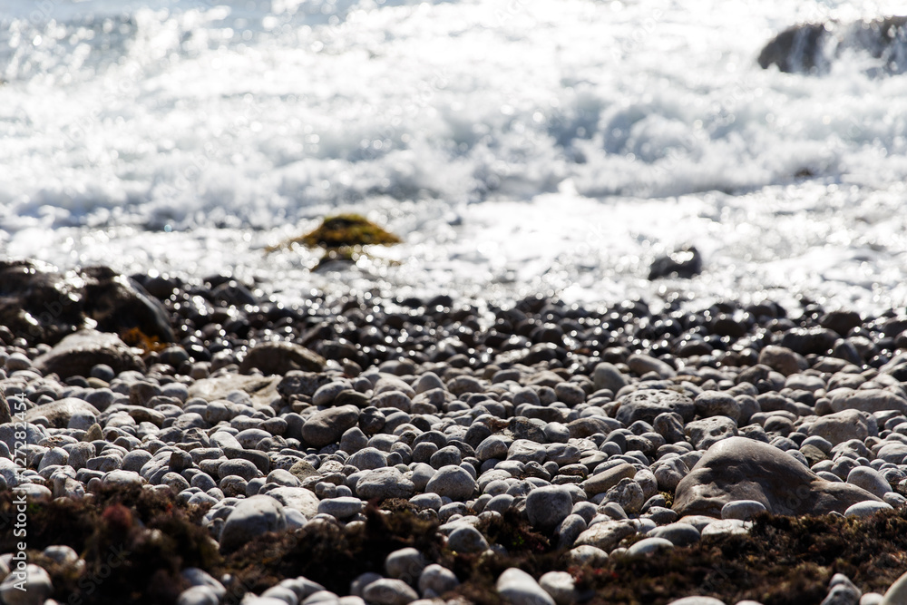Pebbles on beach with waves Pebbles on beach with waves