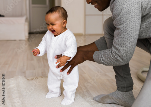 Father Playing With Baby Son At Home photo