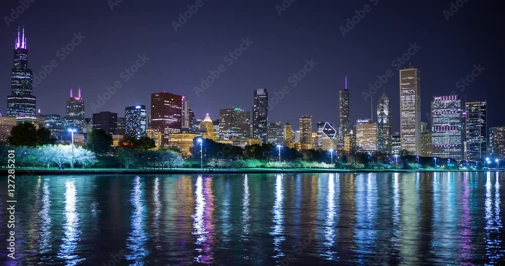 Chicago, Illinois, USA - view from the Lakefront Trail at the Field Museum / Shedd Aquarium facing north at shore of Lake Michigan and the skyline at night - Timelapse with zoom out Chicago, Illinois, USA - view from the Lakefront Trail at the Field Museum / Shedd Aquarium facing north at shore of Lake Michigan and the skyline at night - Timelapse with zoom out