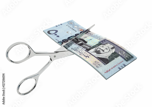 piles of 3D Rendered Saudi money with pair of Scissors isolated on white background photo