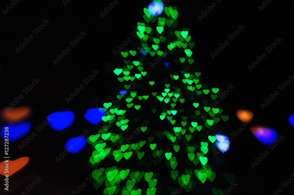 green lights on the Christmas tree in the form of hearts blurry green lights on the Christmas tree in the form of hearts blurry