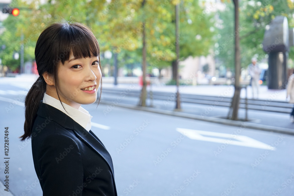 Business woman walking on the street with smile Business woman walking on the street with smile