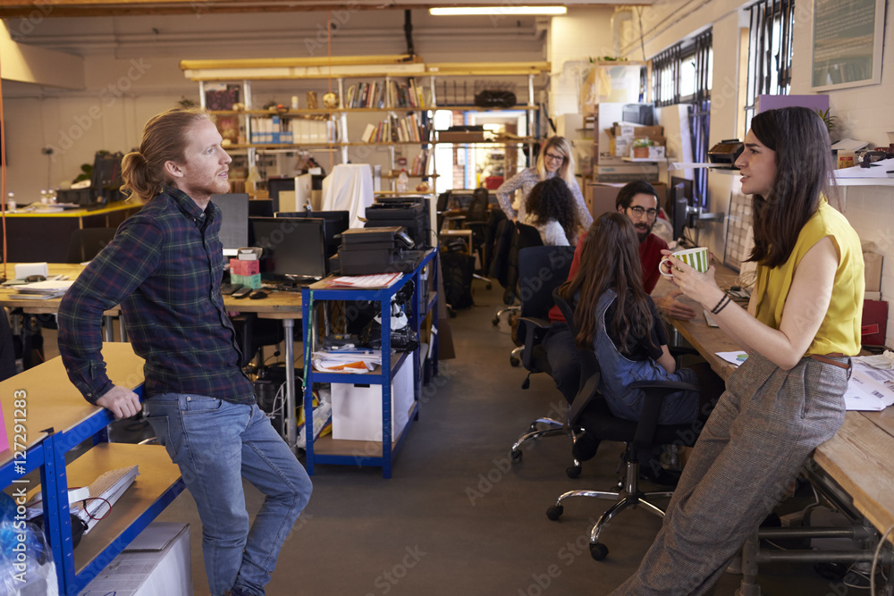 Two Designers Having Informal Meeting In Modern Office Two Designers Having Informal Meeting In Modern Office