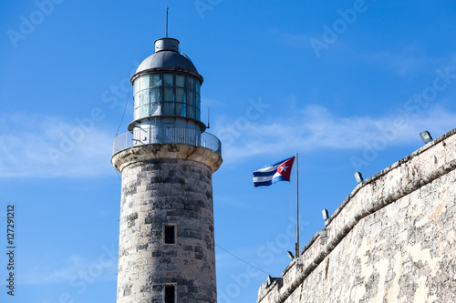 Photography Lighthouse at Castillo del Morro, El Morro Fort in Havana with a waving Cuban fl
