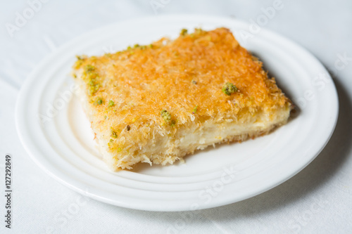 close-up of Arabic dessert Kunafa on a white background