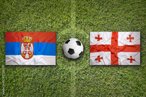 Serbia vs. Georgia flags on soccer field