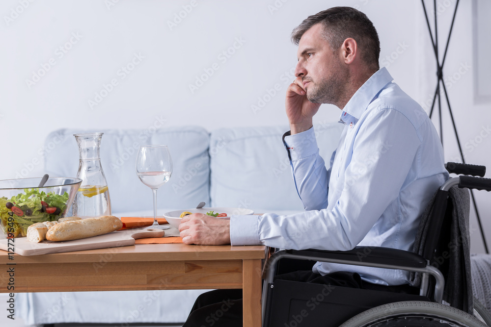 Sad men on a wheelchair